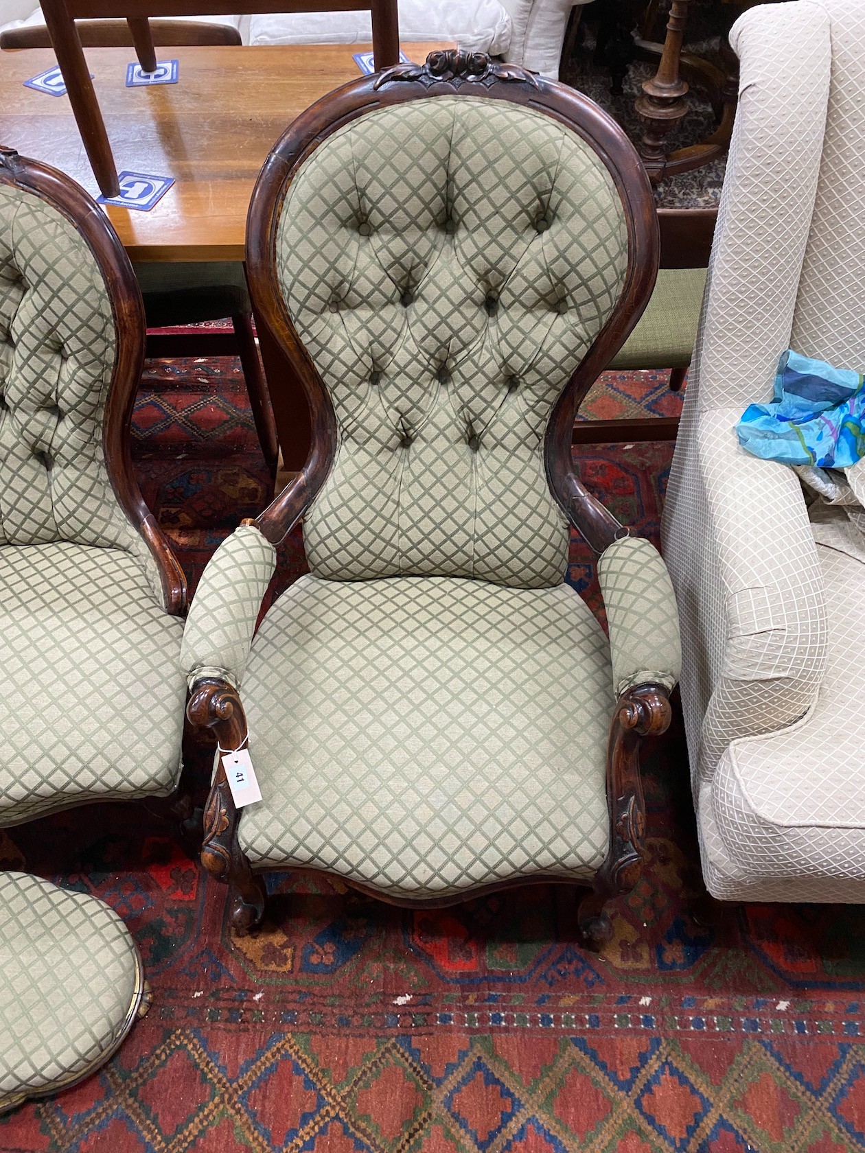 A pair of Victorian carved walnut spoon back chairs, one with arms together with a similar footstool